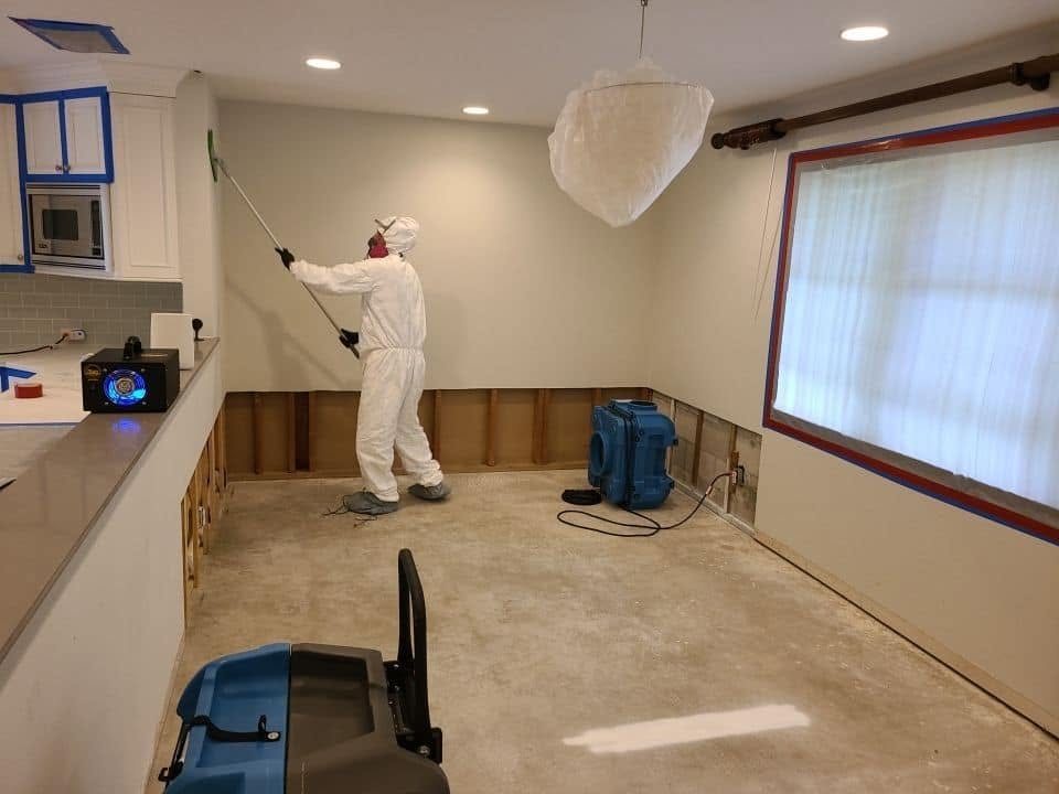 Air scrubber and containment barriers set up during water damage restoration